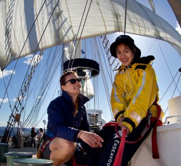 Able Seaman Medic Chantell Flynn encourages a member of the youth crew while she holds a line steady on sail training ship STS Young Endeavour. *** Local Caption *** The national sail training ship STS Young Endeavour sails towards Sydney with a youth crew of 24 young Australians and Royal Australian Navy staff crew embarked.
Direct communication between STS Young Endeavour (LCDR Gavin Dawe) and the helicopter would facilitate better coordination for activity on deck, particularly direction to move the youth crew to the windward rail/bowsprit for the last pass above and then to commence climbing.